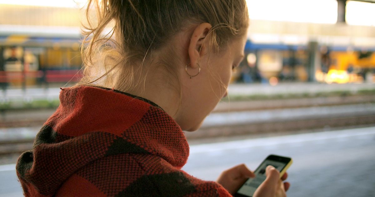 A person reading comments on a phone