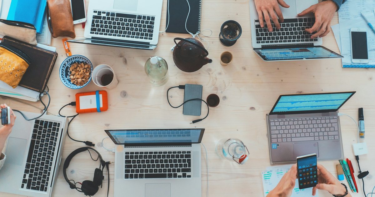 A social media team working at laptops